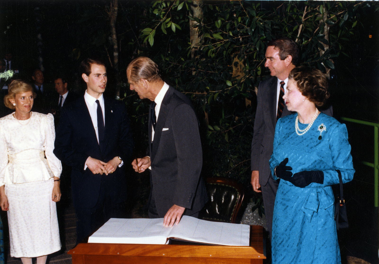 Queensland State Archives Item ID ITM1460355 Her Majesty Queen Elizabeth II, HRH The Duke of Edinburgh and HRH Prince Edward signing guest book at Expo 88, Brisbane